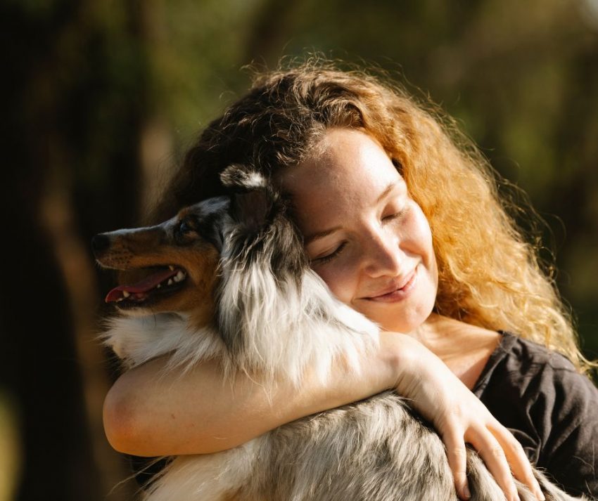 Woman hugging her emotional support animal dog